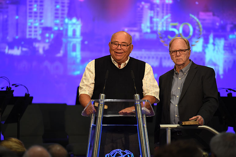 /><br />
</strong><em>Kåre J. Smith was present, and thanked those that had been along from the start. Photo: BCC</em></p>
<h4>The pioneers that went before us</h4>
<p>The stories of the American pioneers reminded us of the forerunners we have in the church. In 1934 Johan O. Smith wrote to Elias Aslaksen: <em>“The churches round about the country are flourishing and bearing fruit. In Denmark, too, the seed is springing up and growing day and night. It has been sown in America. We can rejoice over all this. And what does the future hold? Our children and grandchildren will continue to sow the seed. The children in the church will continue to bear fruit and seed far into the future.”</em></p>
<p>One of the first contacts in Salem was Monrad Grannes, who labored faithfully and tirelessly for many years in hope that God would raise up a church in North America. He would often say “Time is short! Use it well.” Grannes also understood the importance of participating in the international conferences at Brunstad, and encouraged his friends in Salem to go to Norway and spend time where members from many countries were gathered to hear the preaching of the same gospel.</p>
<p>Many friends worked at length to put Salem’s story together through pictures. Pictures showed the first generation as well as the large influx in the 1980s, of those who were longing for a new life. On display was Monrad Grannes’ first wire recorder from 1950. He was early out in putting technology to use, and sent a counterpart to Norway so they would record meetings and conferences and send them back to him in the U.S.</p>
<p><img decoding=